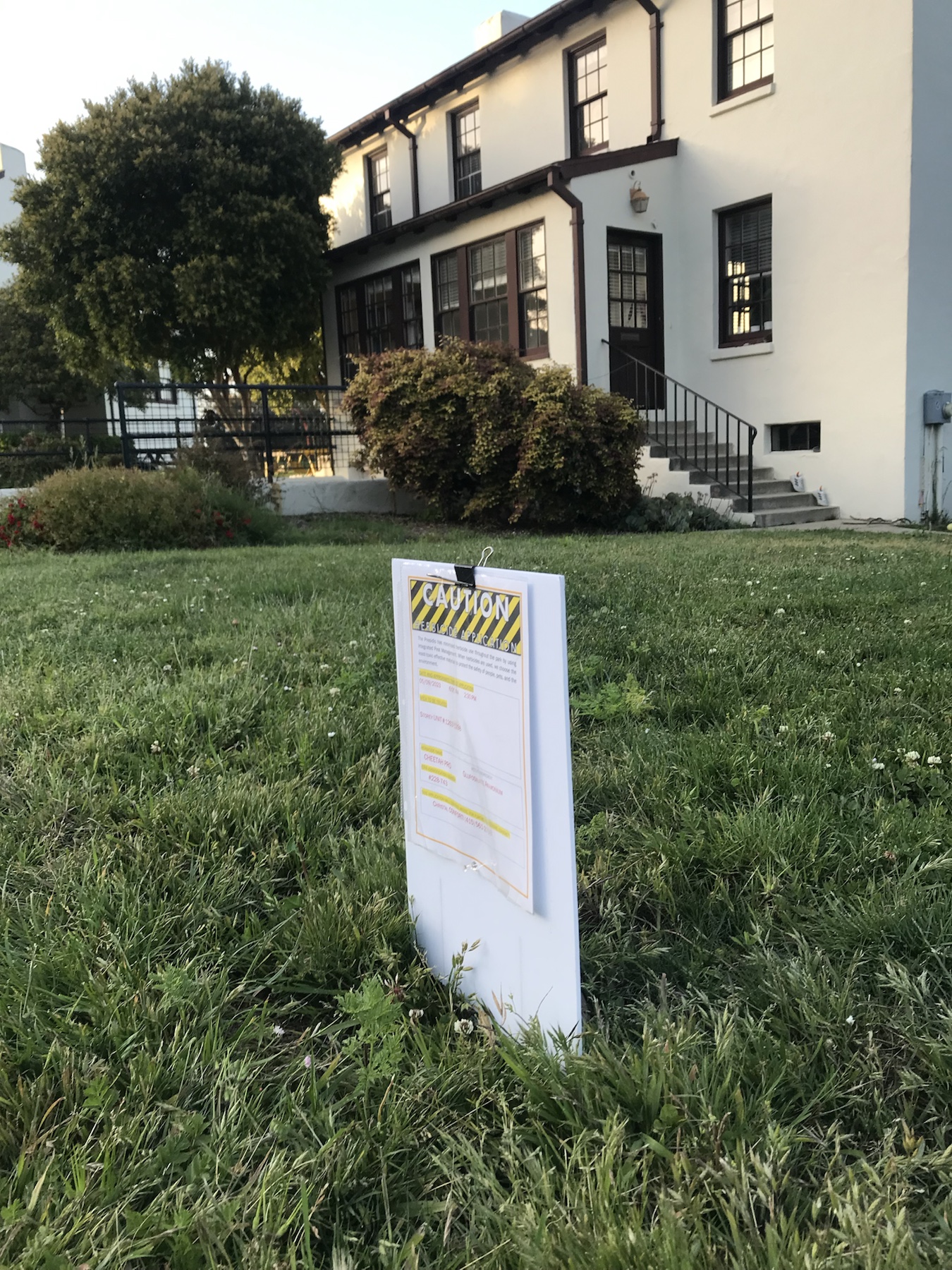 Context image of a Cheetah Pro herbicide application sign near Storey residential units in the Presidio