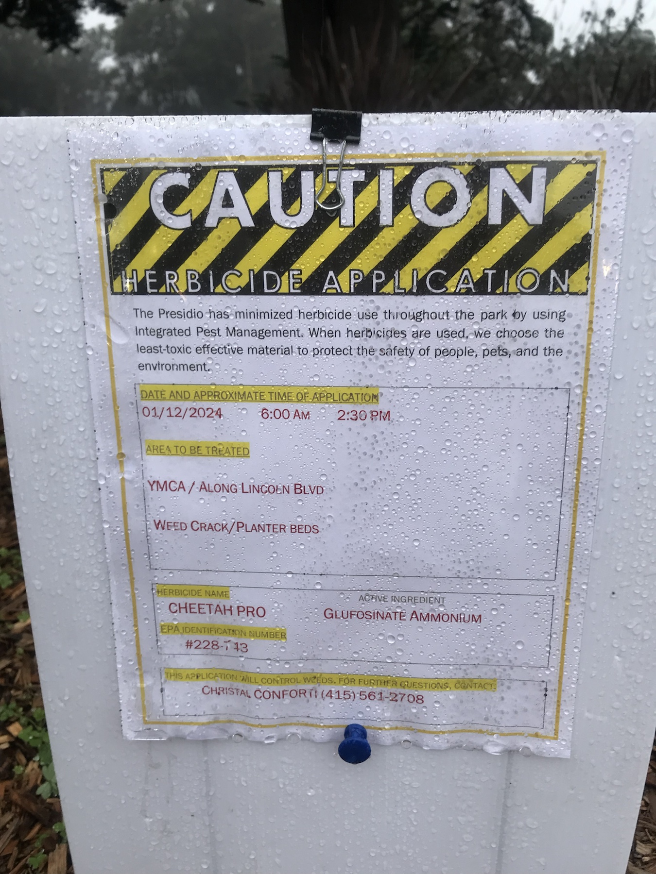 Close-up Cheetah Pro herbicide application sign showing date and treated area