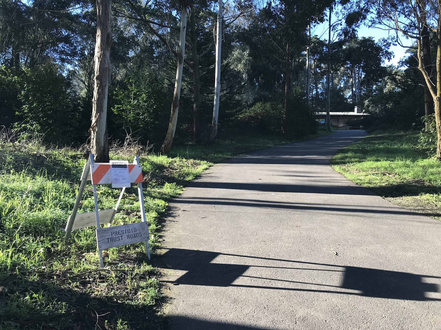 Context image of a Roundup herbicide application sign beside a Presidio Trust road
