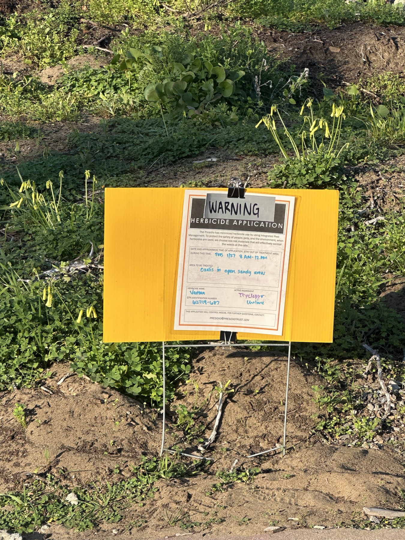 Warning herbicide application sign for Vastlan and triclopyr choline in open sandy areas