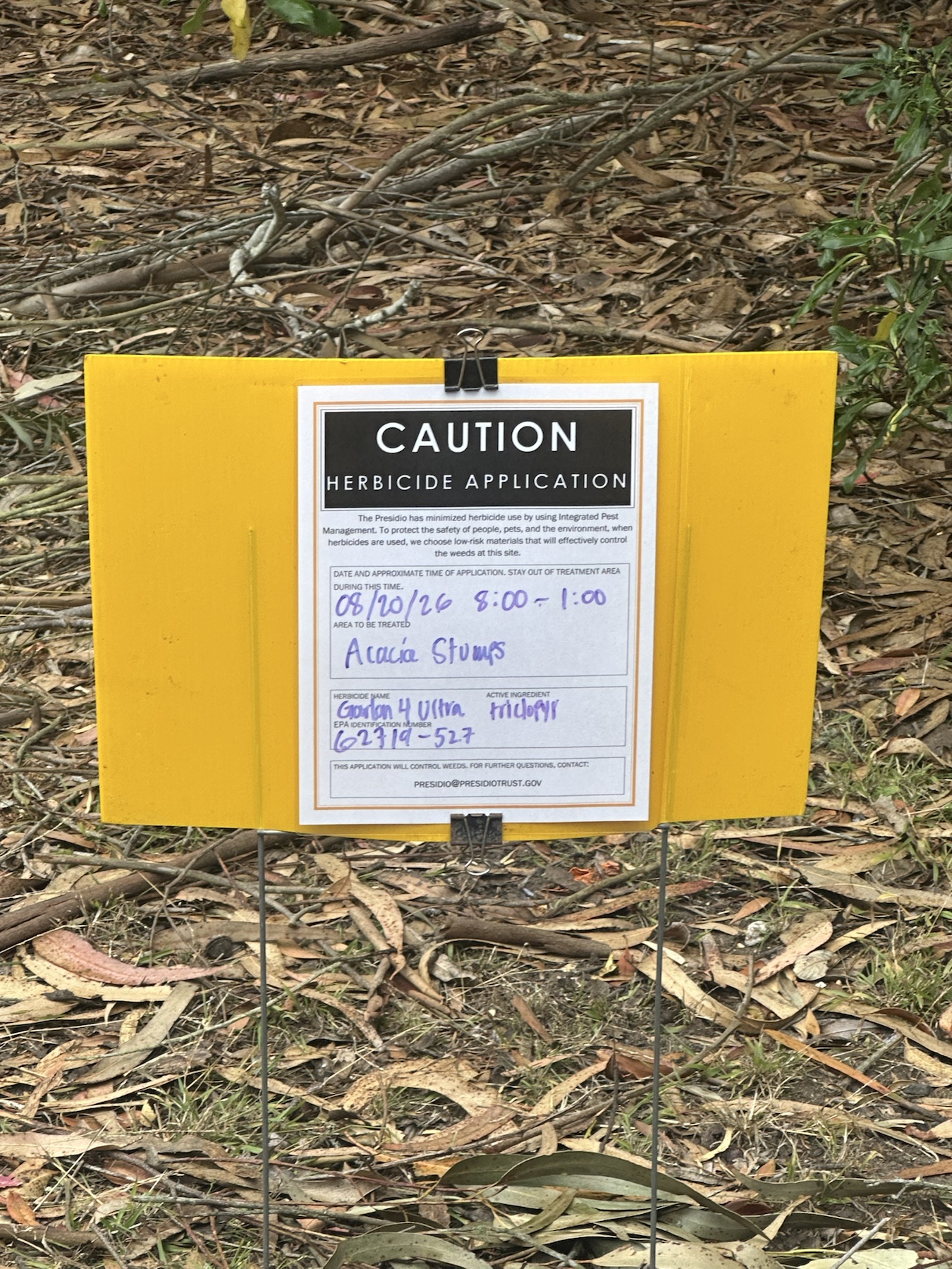 Caution herbicide application sign listing Garlon 4 Ultra for acacia stumps