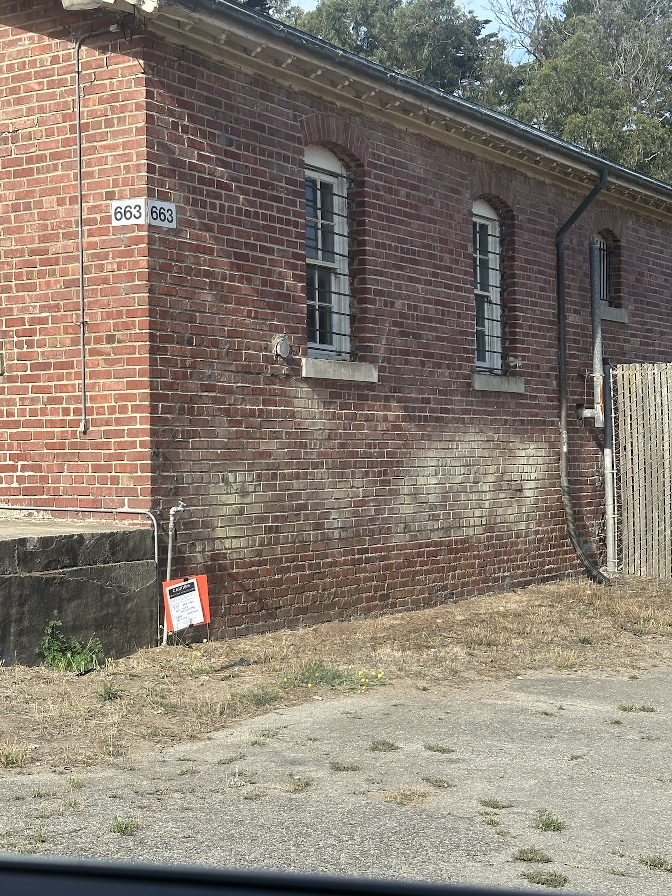 Context image of a Rodeo herbicide application sign beside Building 663