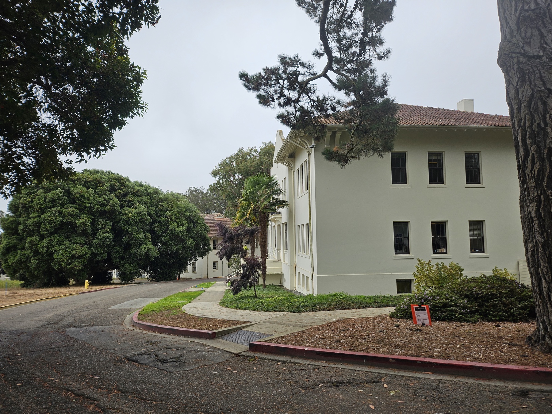 Wide view of Roundup herbicide sign near Presidio buildings 1201 and 1202