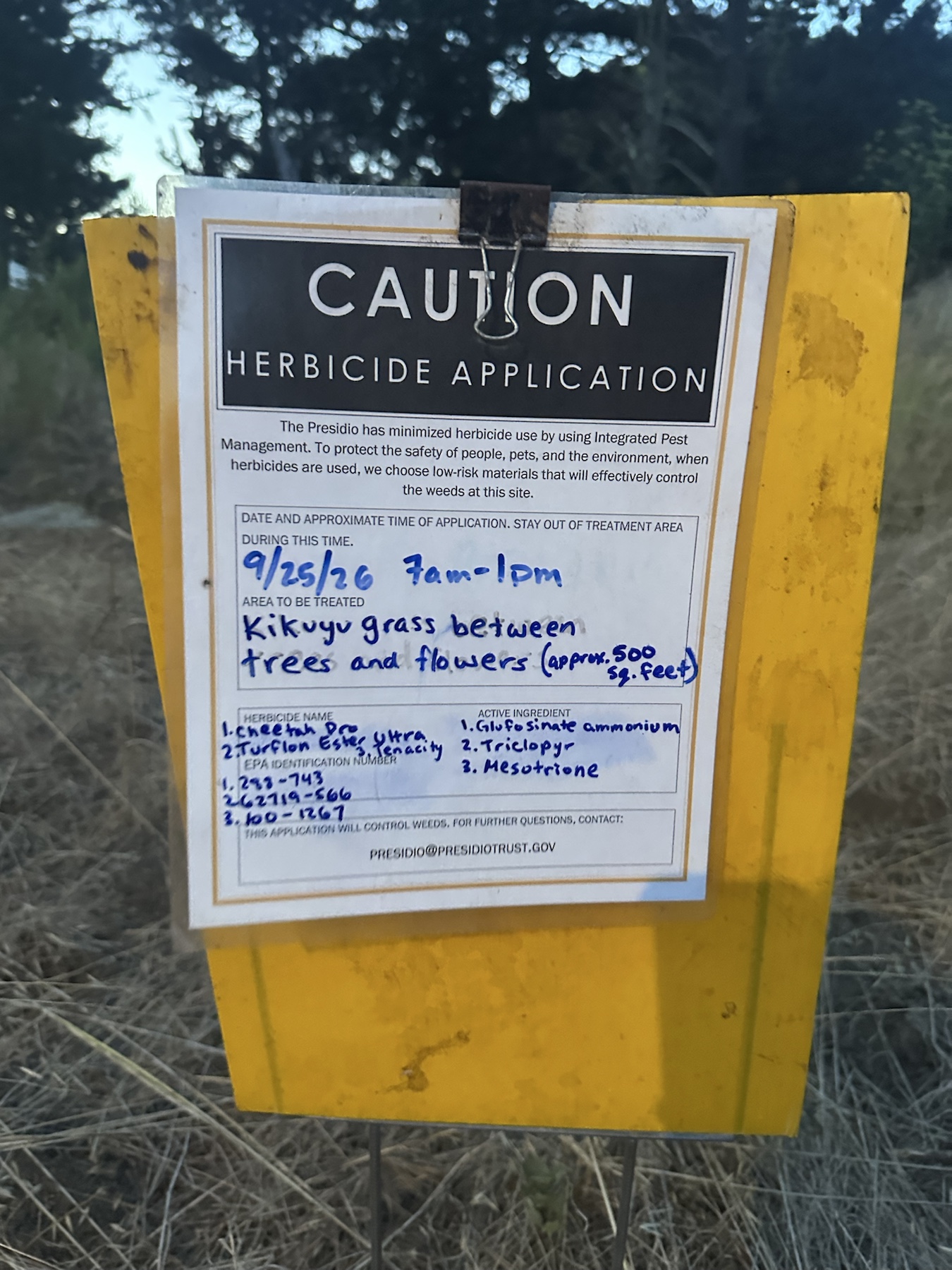 Caution herbicide application sign for kikuyu grass listing three herbicides