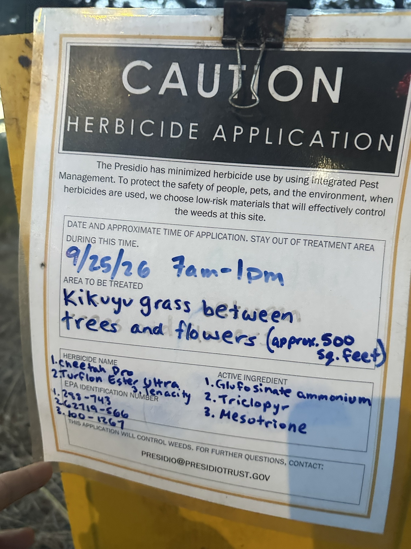 Close-up herbicide sign dated September 25 2026 for kikuyu grass treatment